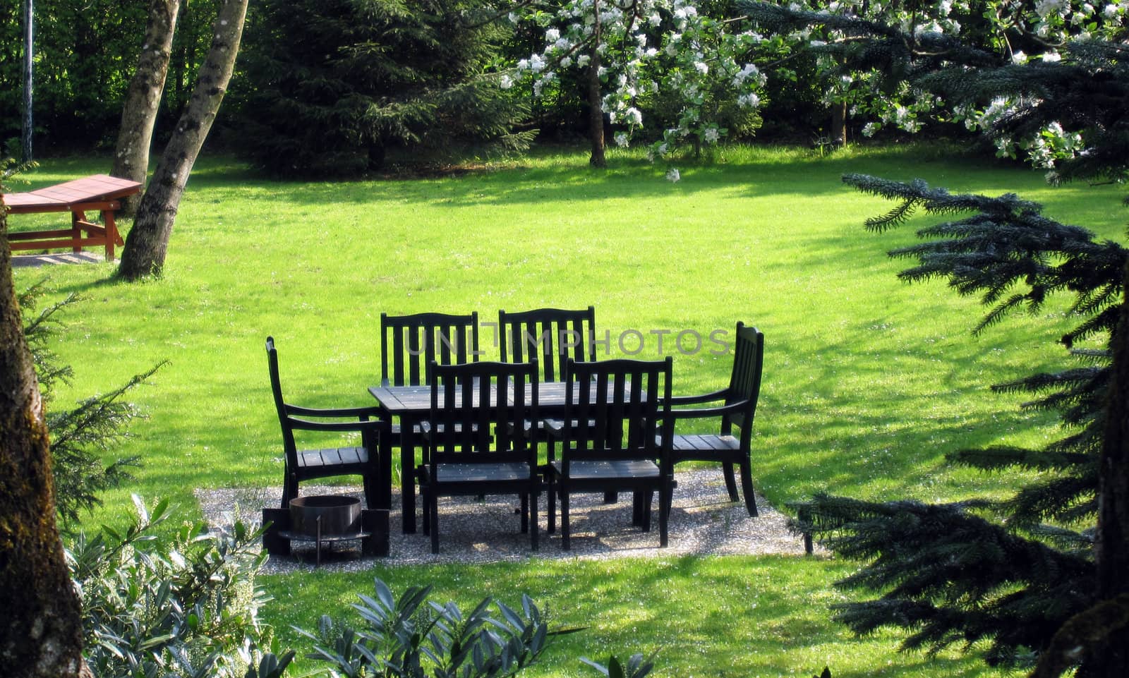 table and chairs outdoors in a nice garden