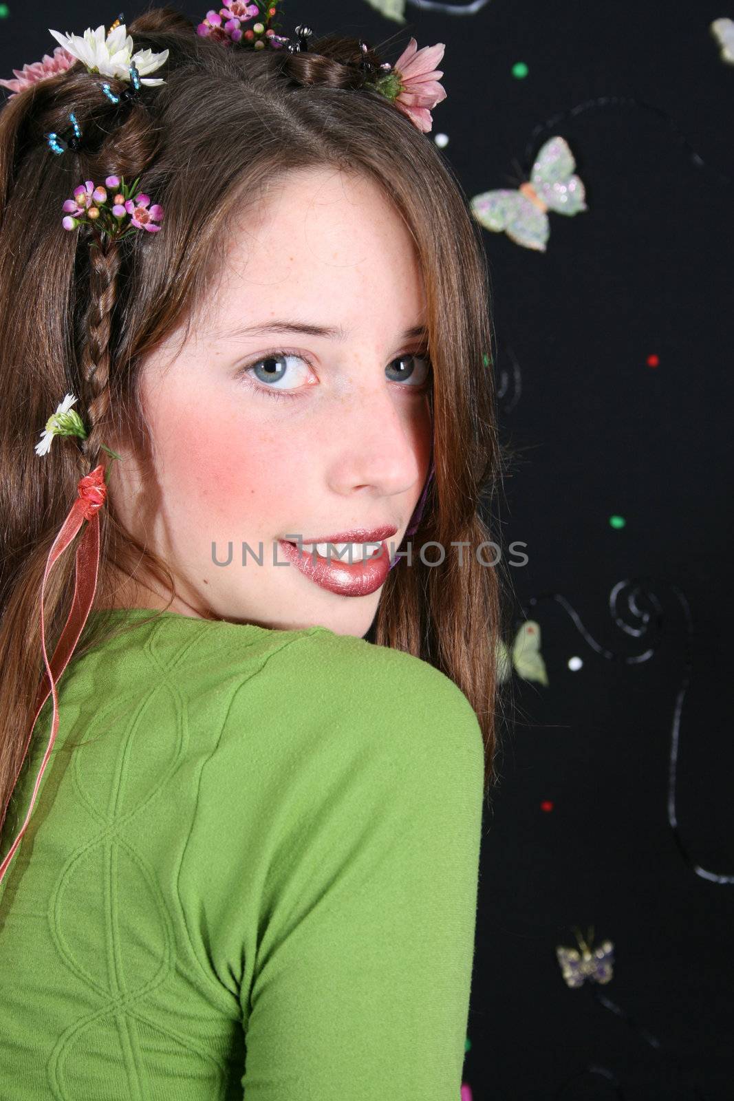 Teenage model with flowers and butterflies in her hair