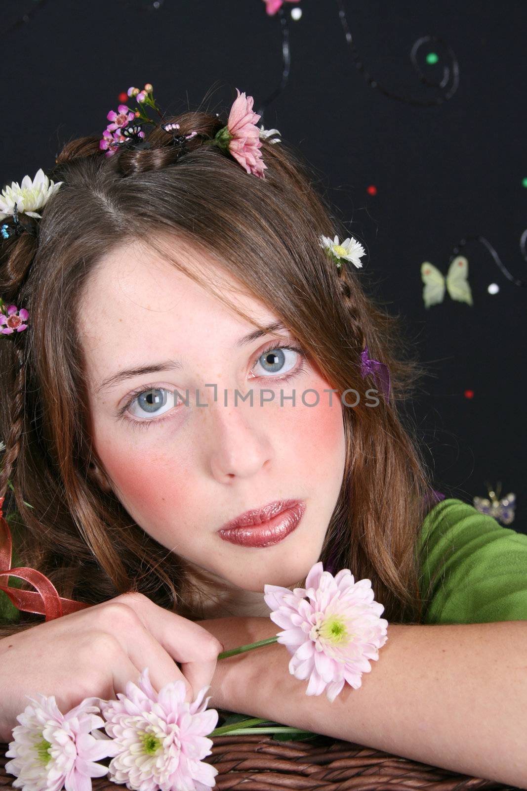 Teenage model with flowers and butterflies in her hair