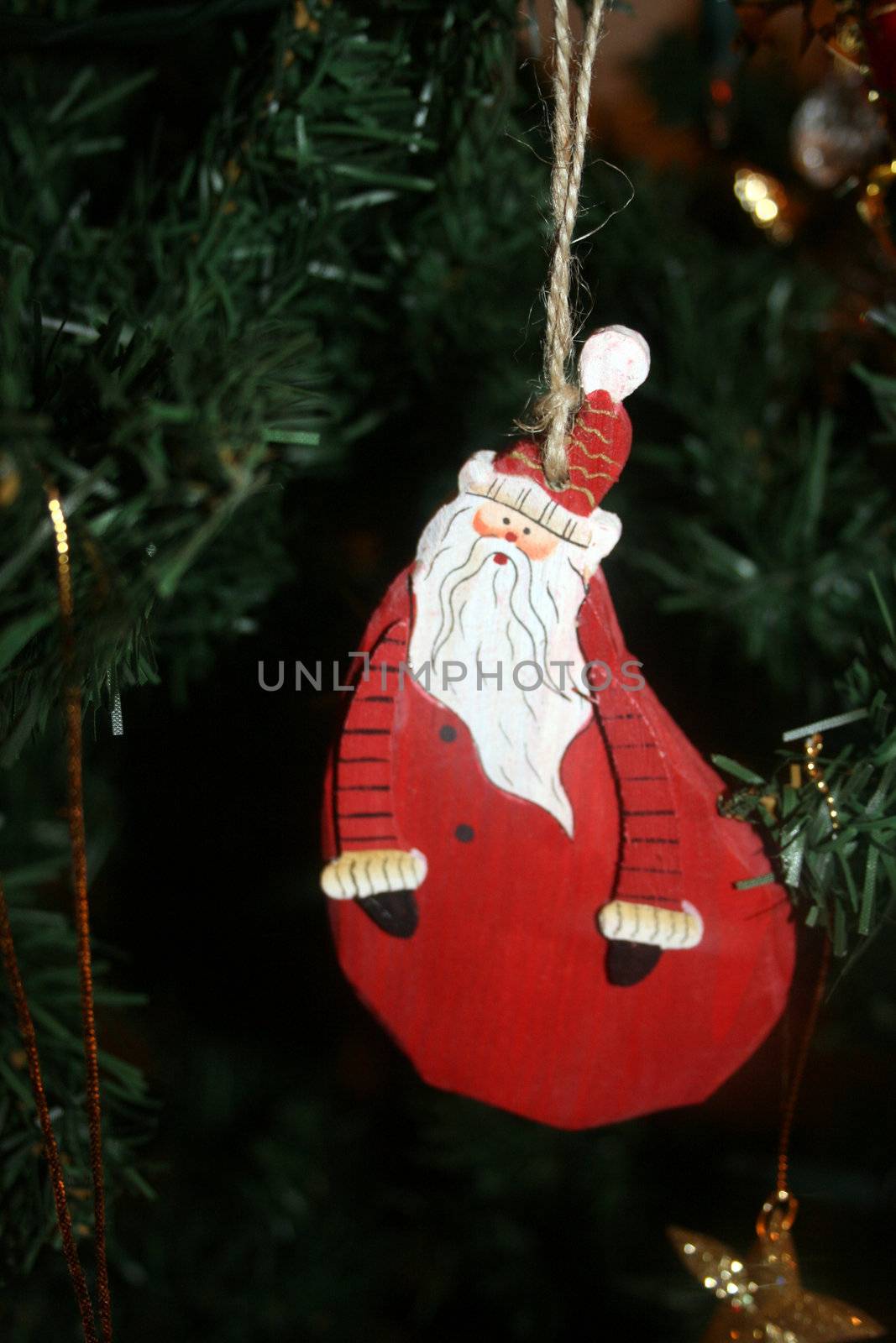 Father Christmas decoration hanging on a tree
