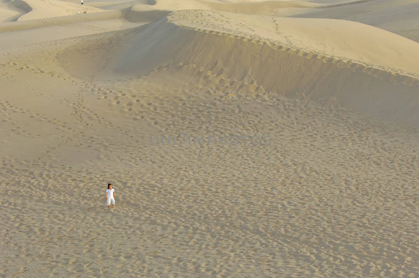 Child is all alone in a desert
