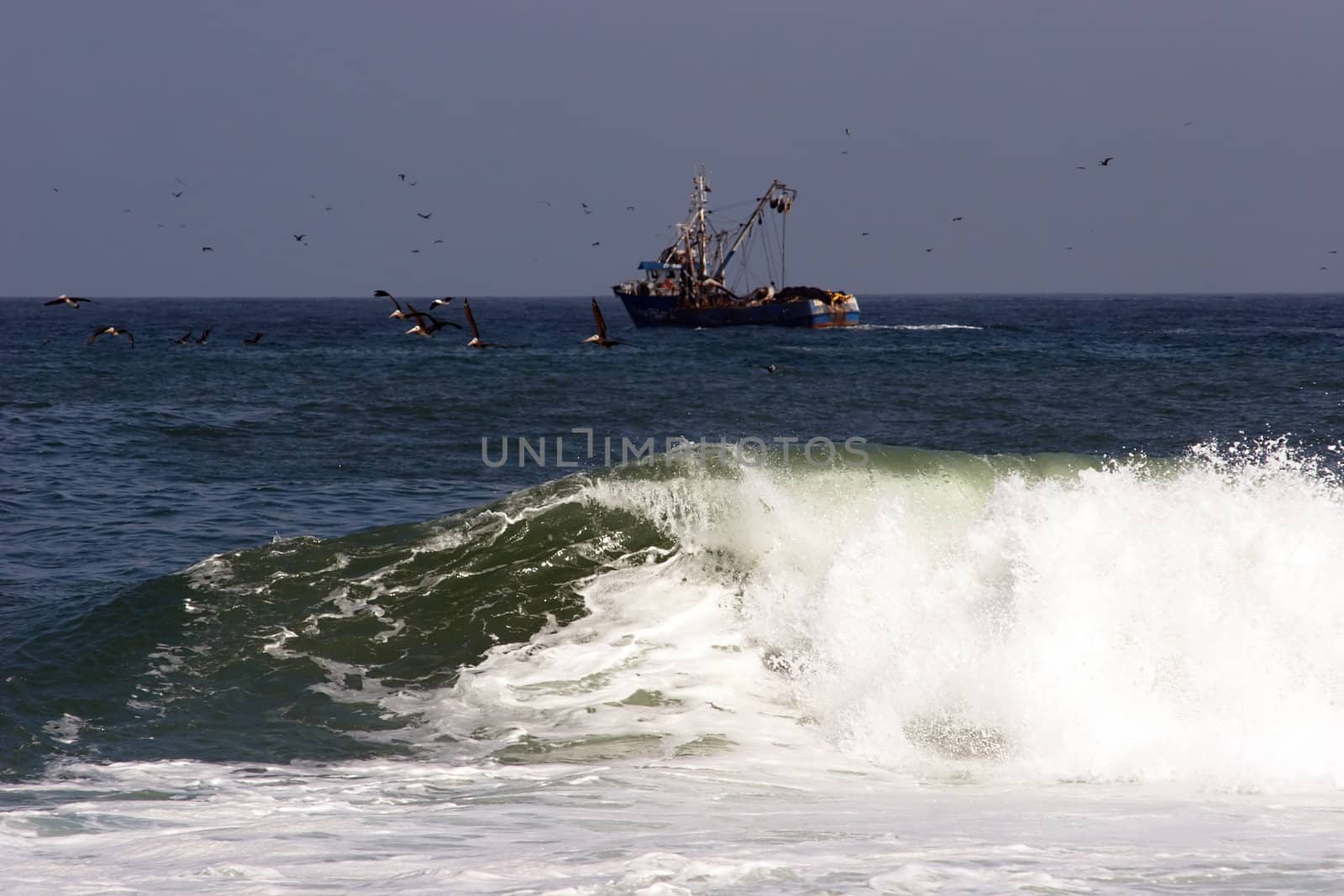 Surf and a trawler in the background by azotov