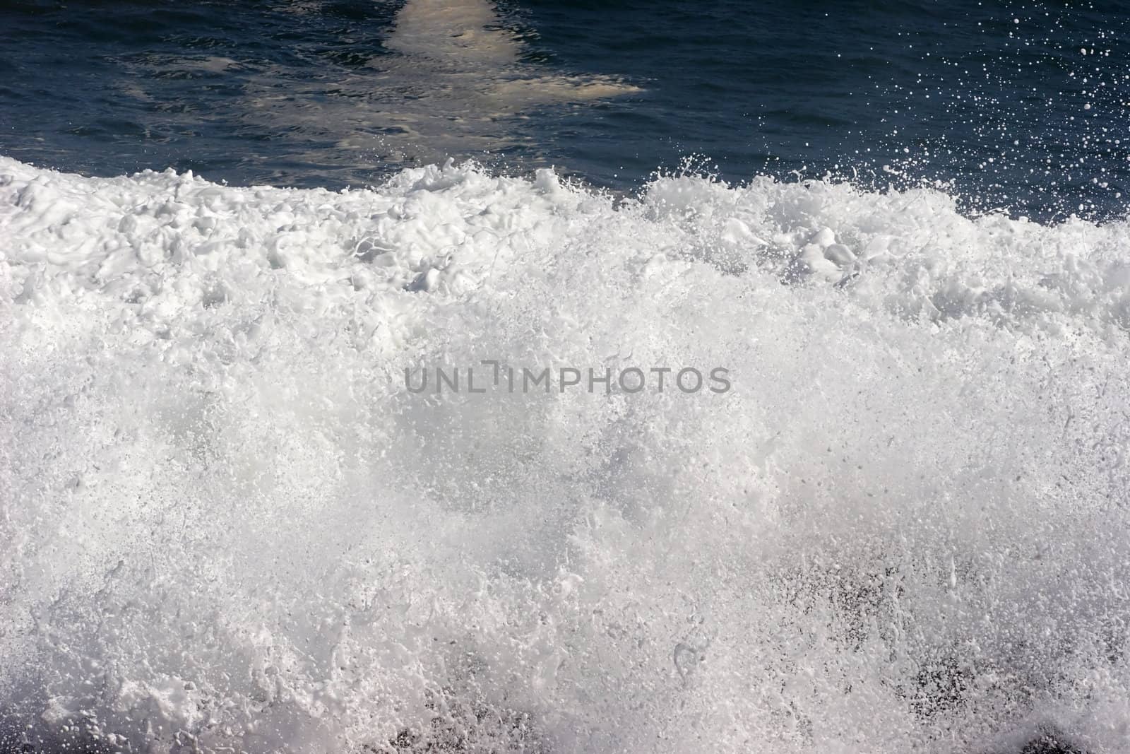 Wave crashing on the shore at Arica harbor, Chile, Pacific Ocean