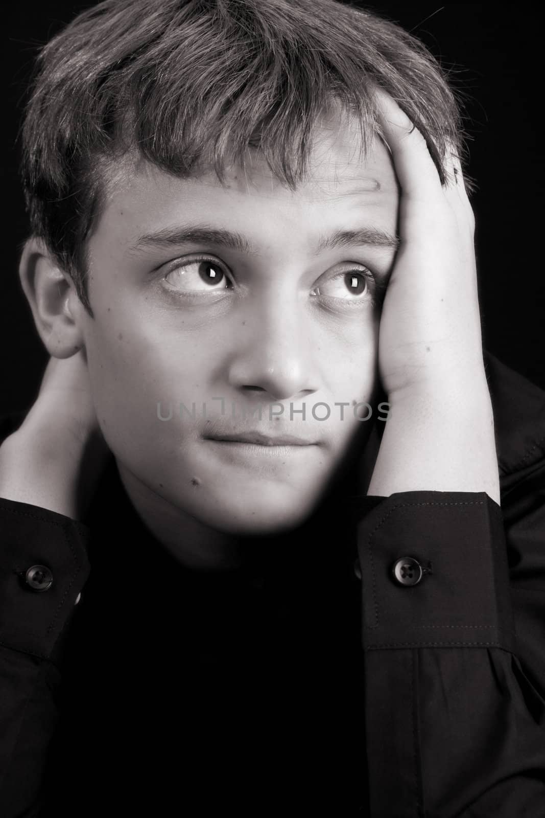 Teenage male in casual attire looking into the distance