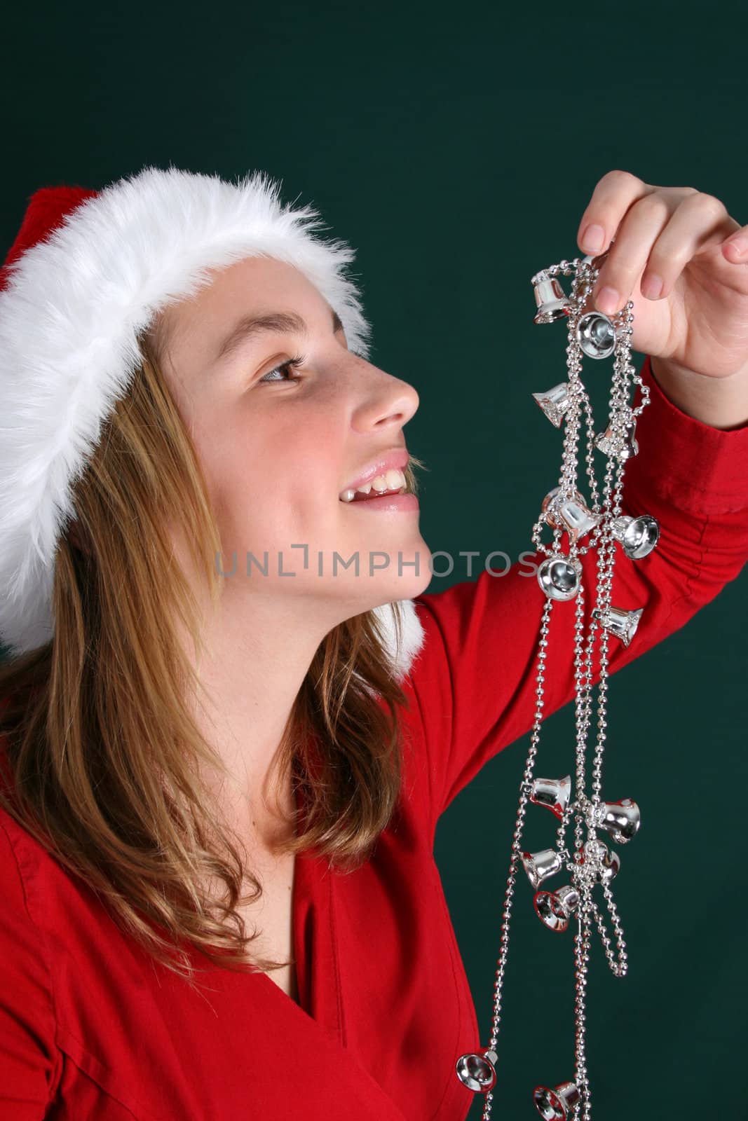 Beautiful teenager wearing a red shirt and christmas hat