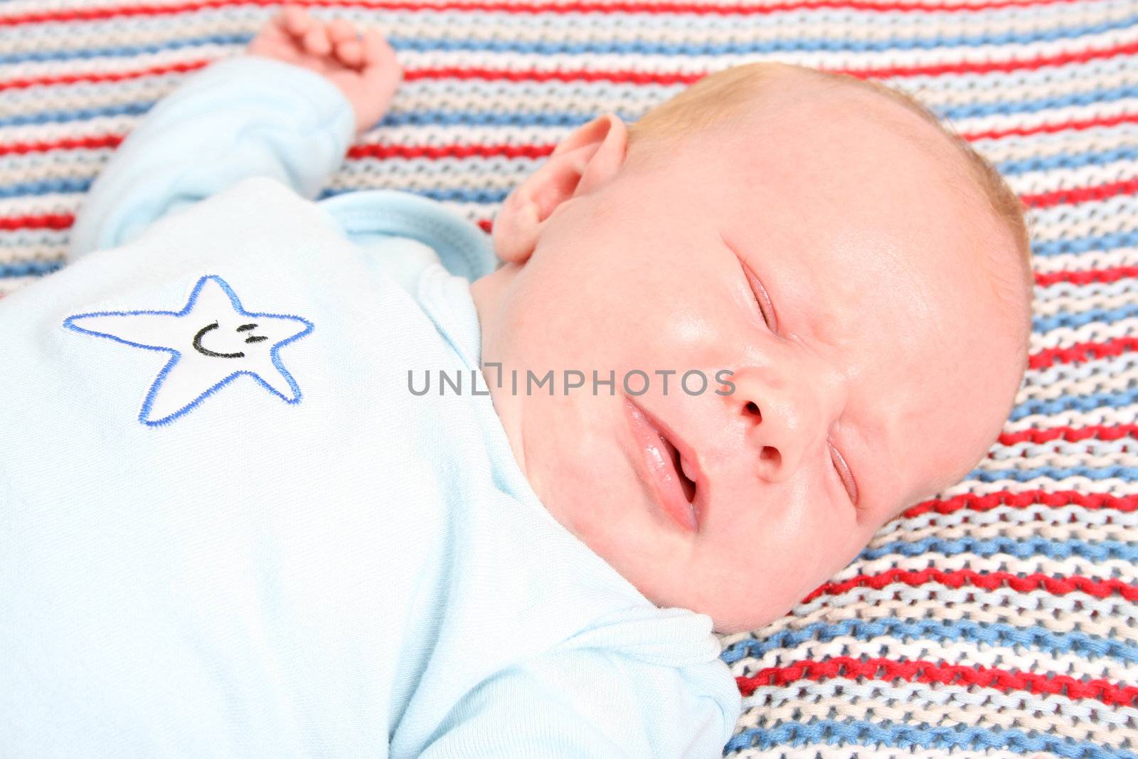 Month old baby boy on a colorful blanket 