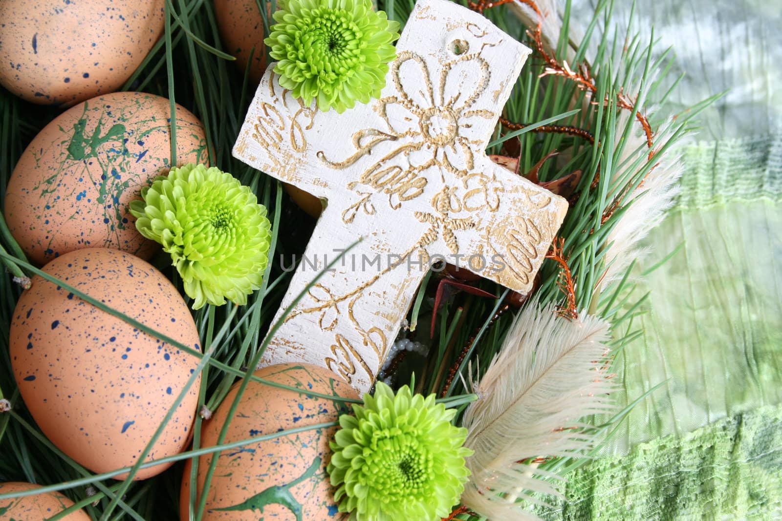 Decorated eggs in a wreath on a green background
