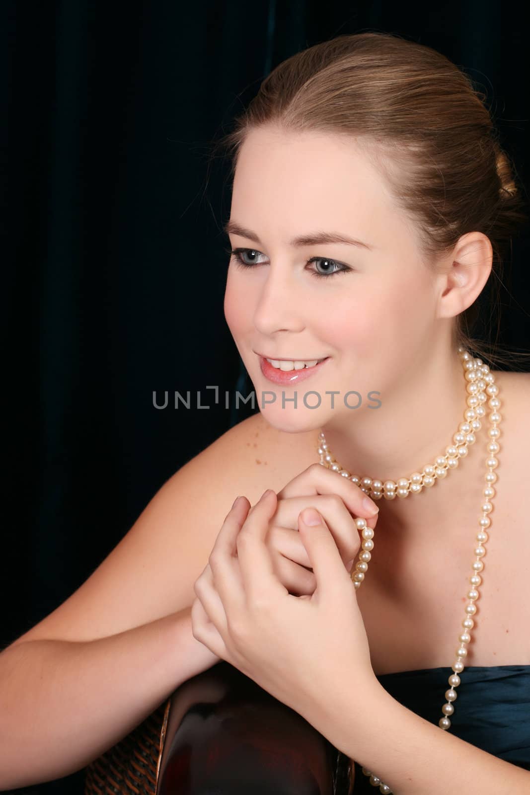 Beautiful female wrapped in fabric, wearing pearls