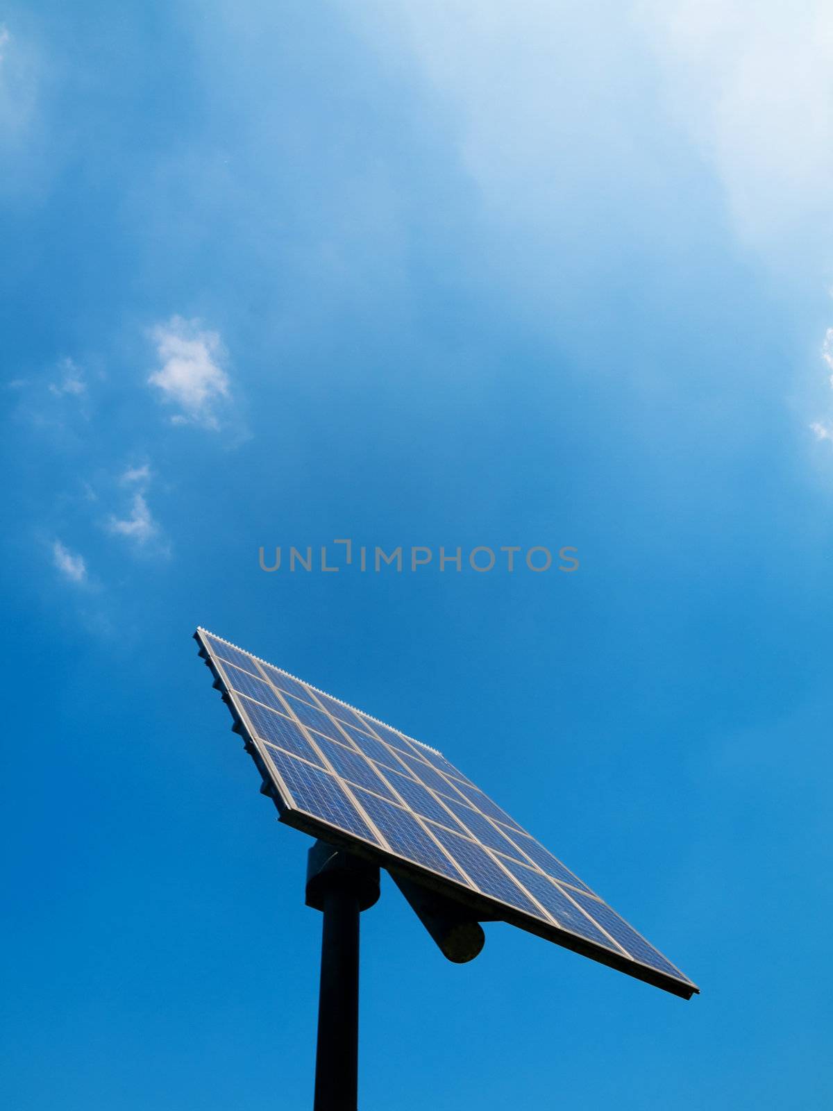 Solar panel under blue sky with clouds
