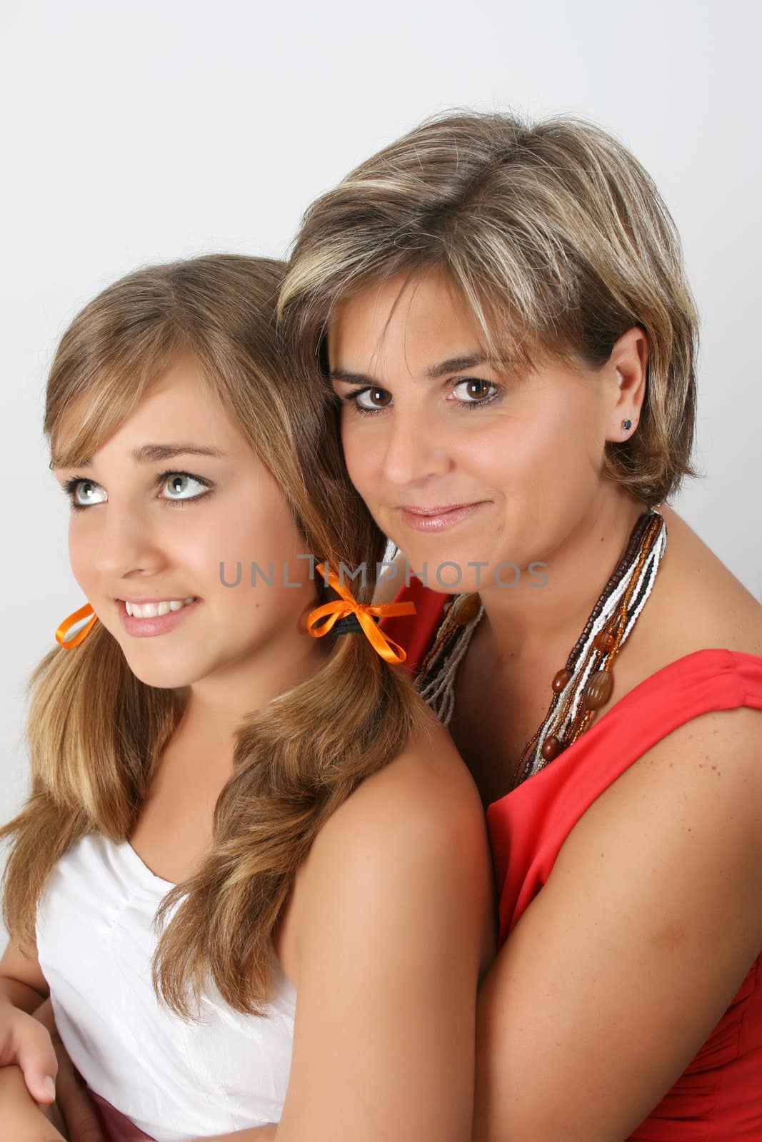 Beautiful mother and daughter on a white background