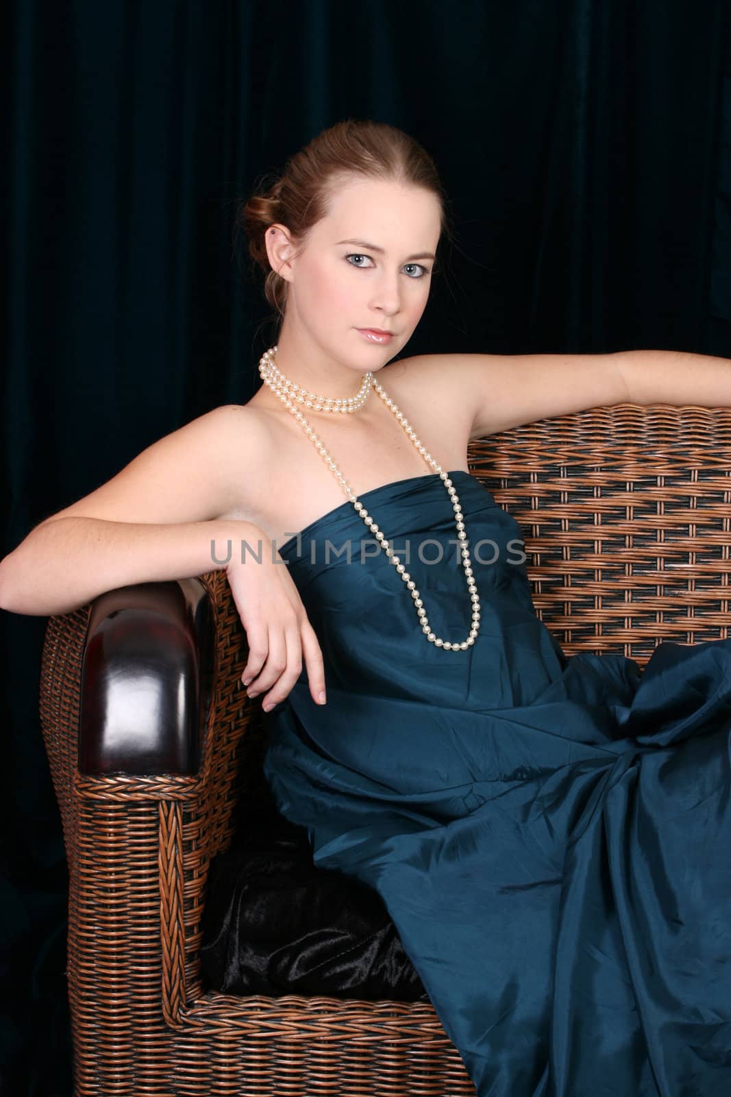 Beautiful female wrapped in fabric, wearing pearls 