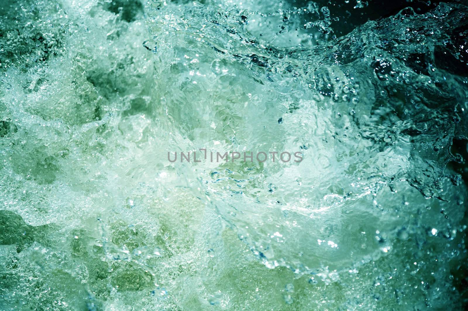 The abstract background from greenish raging water