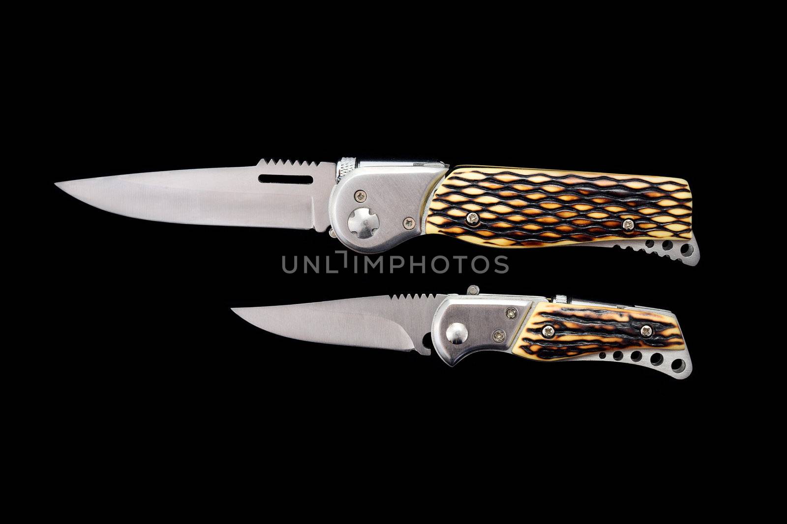 Two little pen-knifes on a black background