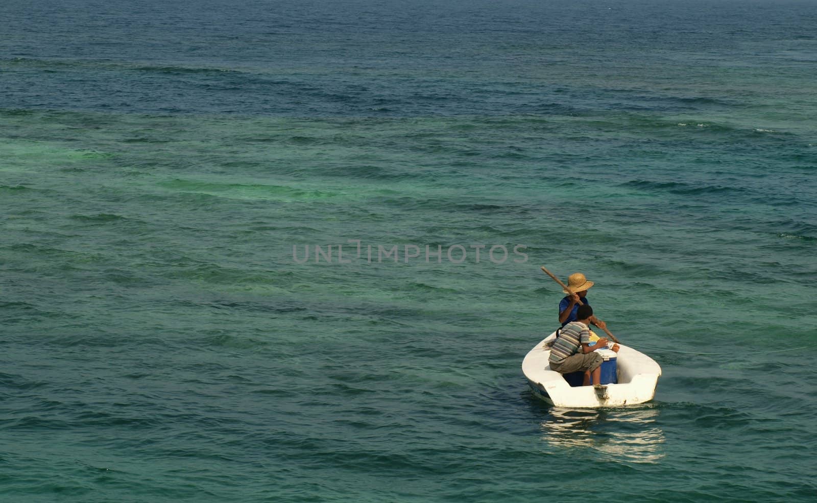 Men fishing in Caribbean ocean with a small boat for living