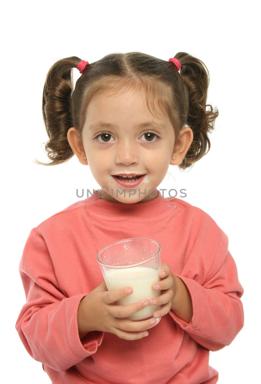Toddler enjoying a glass of fresh milk