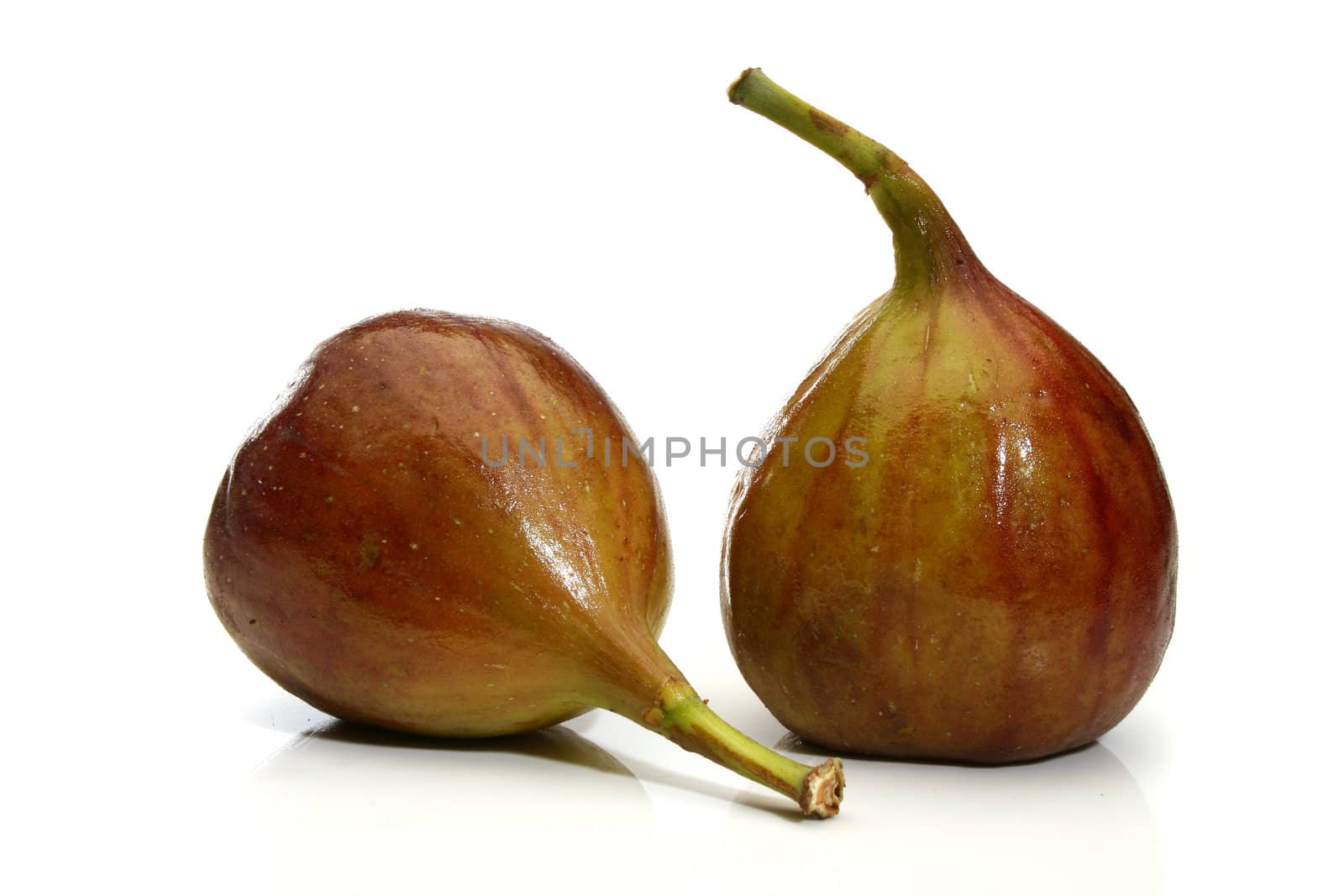Two delicious figs over a white background