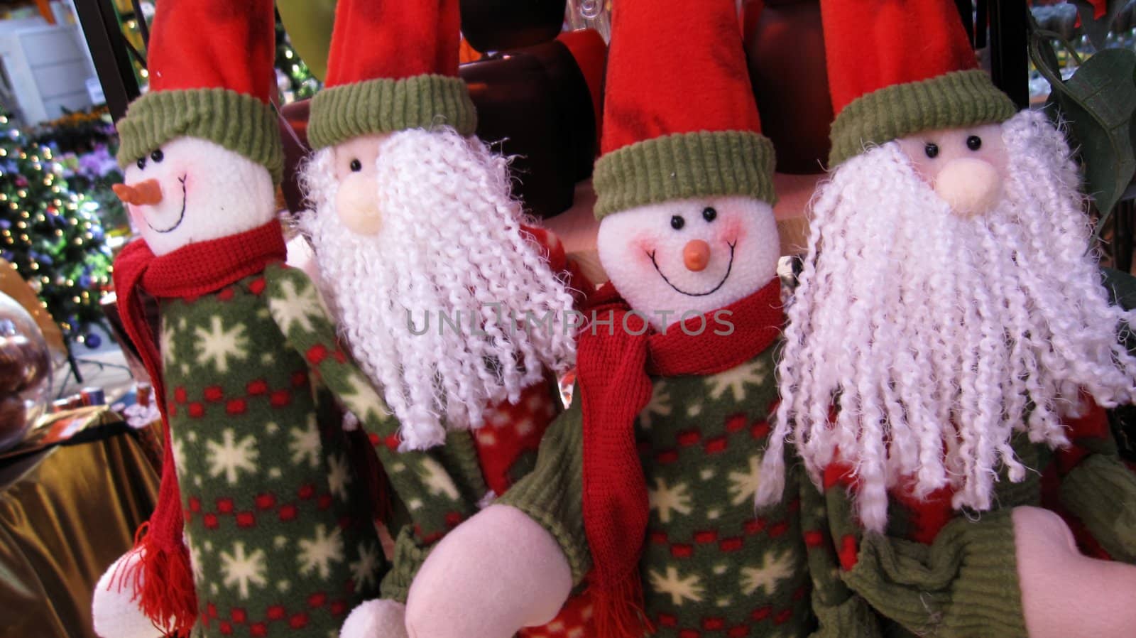 four people in santa claus look are celebrating christmas