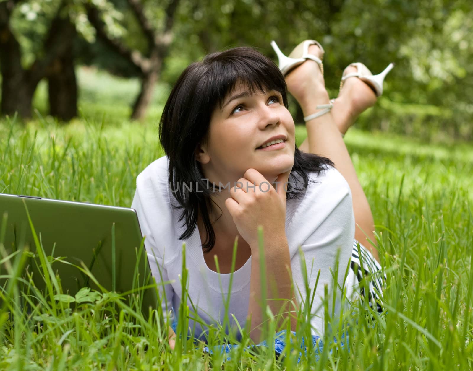 woman with laptop in park