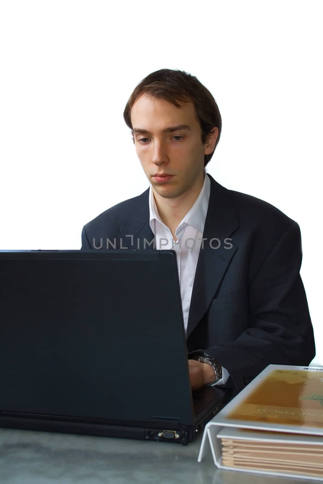 Young man works on laptop, isolated over white