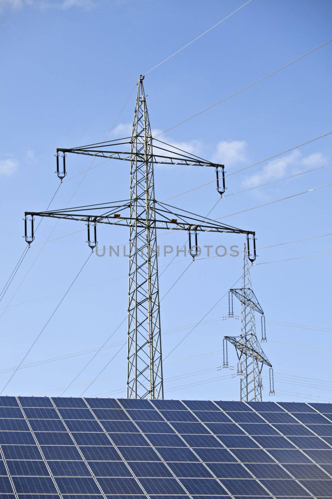 solar panels and a pylon on a sunny day