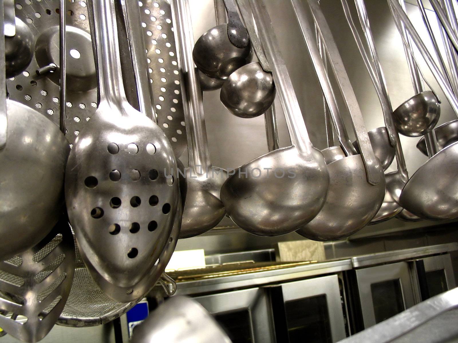 These spoons and ladles are tools of the trade for a chef in a commercial kitchen.