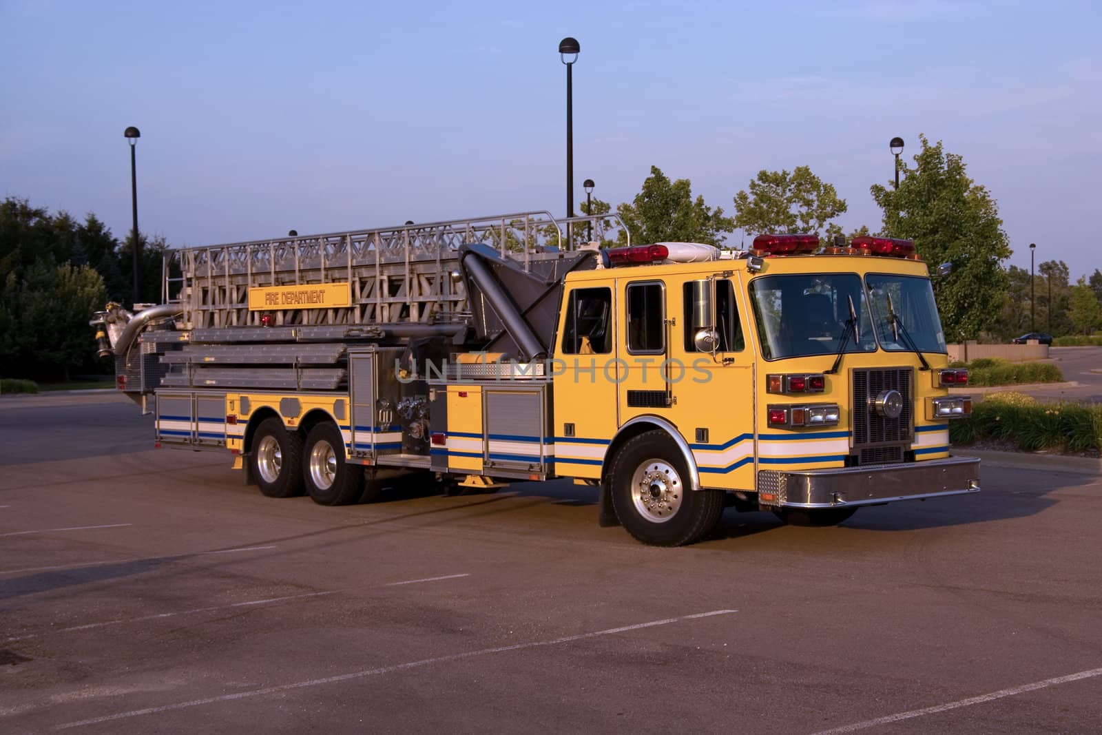 This is a front angle view of a fire truck with a ladder and bucket.