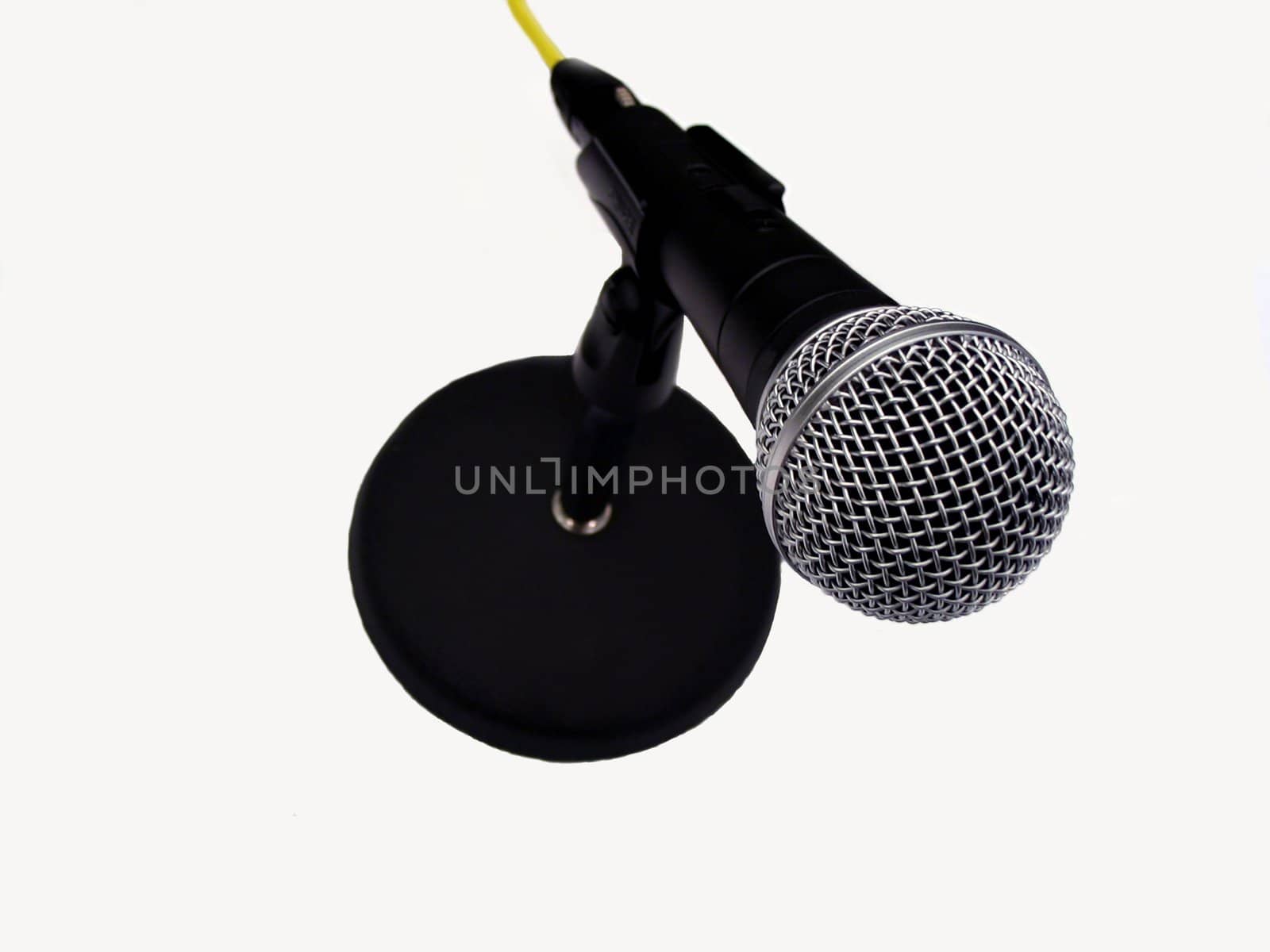 This is a picture of a microphone on a table stand isolated on a white background.