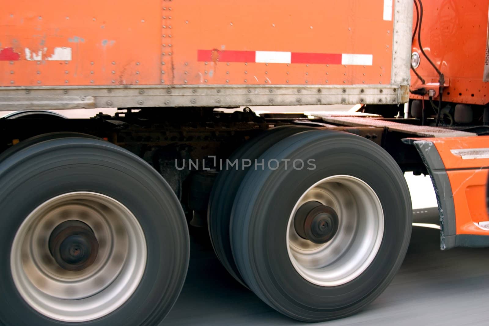 This is a picture of a big truck moving freight with the hammer down on the super slab.