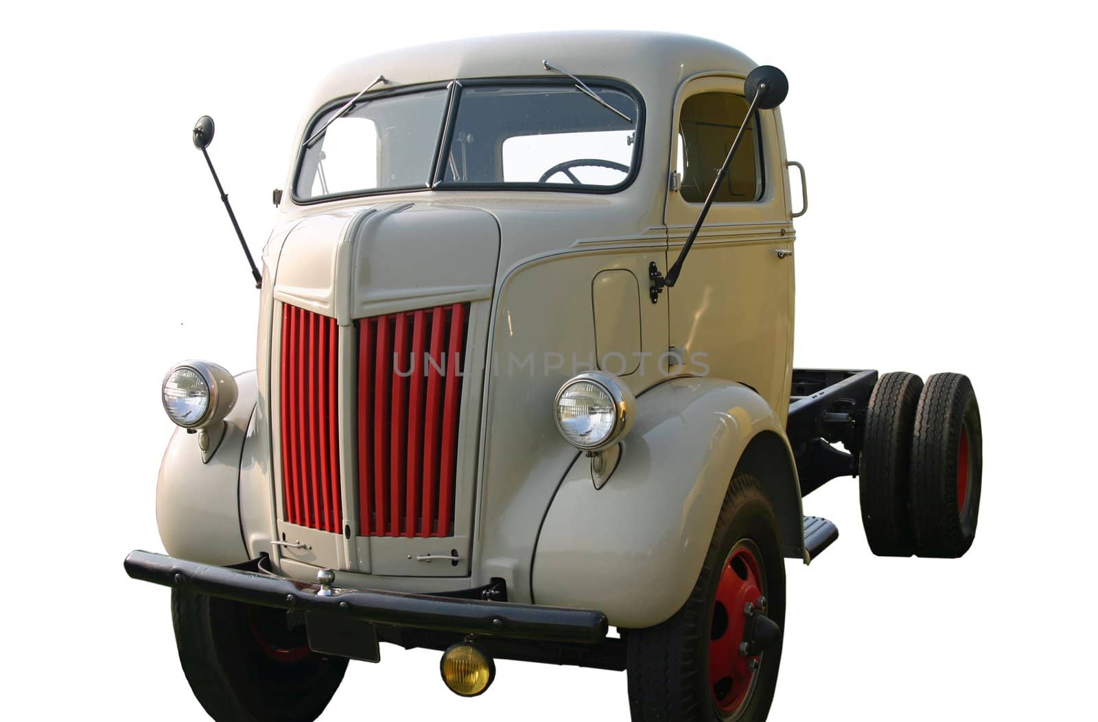 This is a picture of a 1940’s cab-over tractor trailer truck without a trailer, taken at a low angle of the front corner. It has been cut-out and isolated with a white background. 