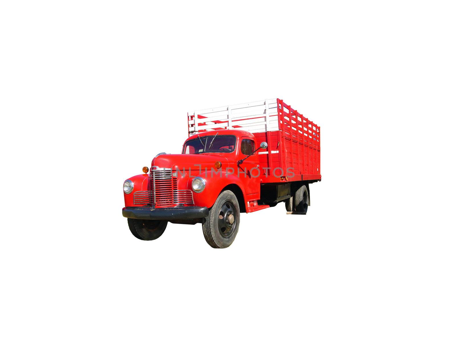 This is a picture of an old red 1940s flat bed stake style farm truck, isolated on white.