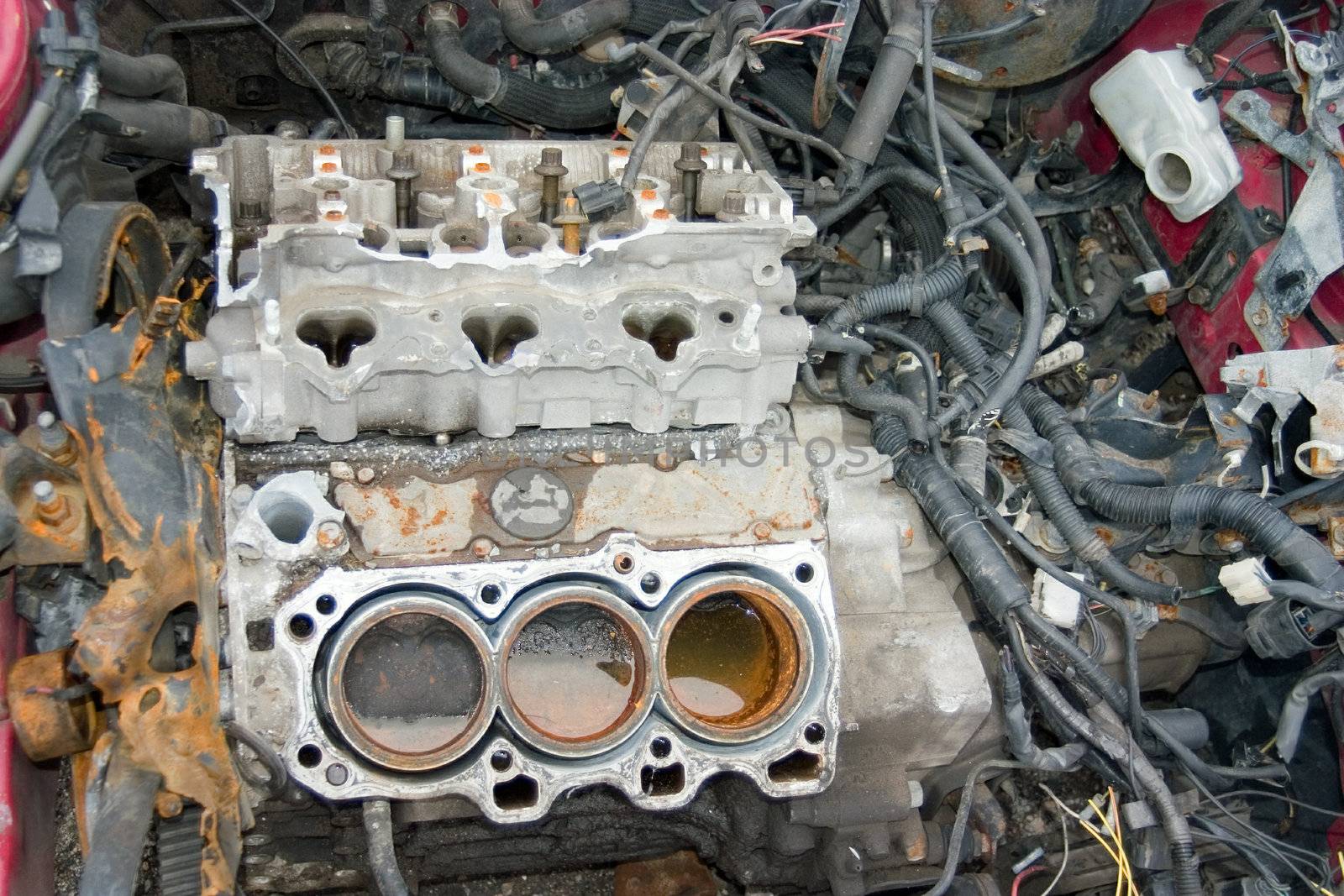 This is an engine block in a stolen sports car that has been stripped of all useable parts.