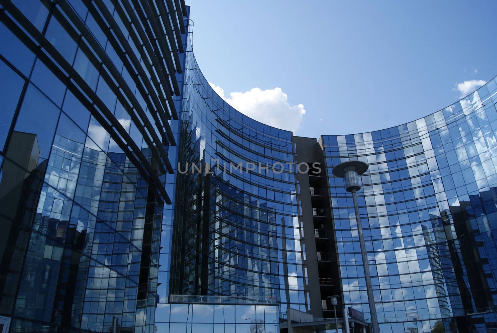 Modern office high building is constructed of glass and concrete