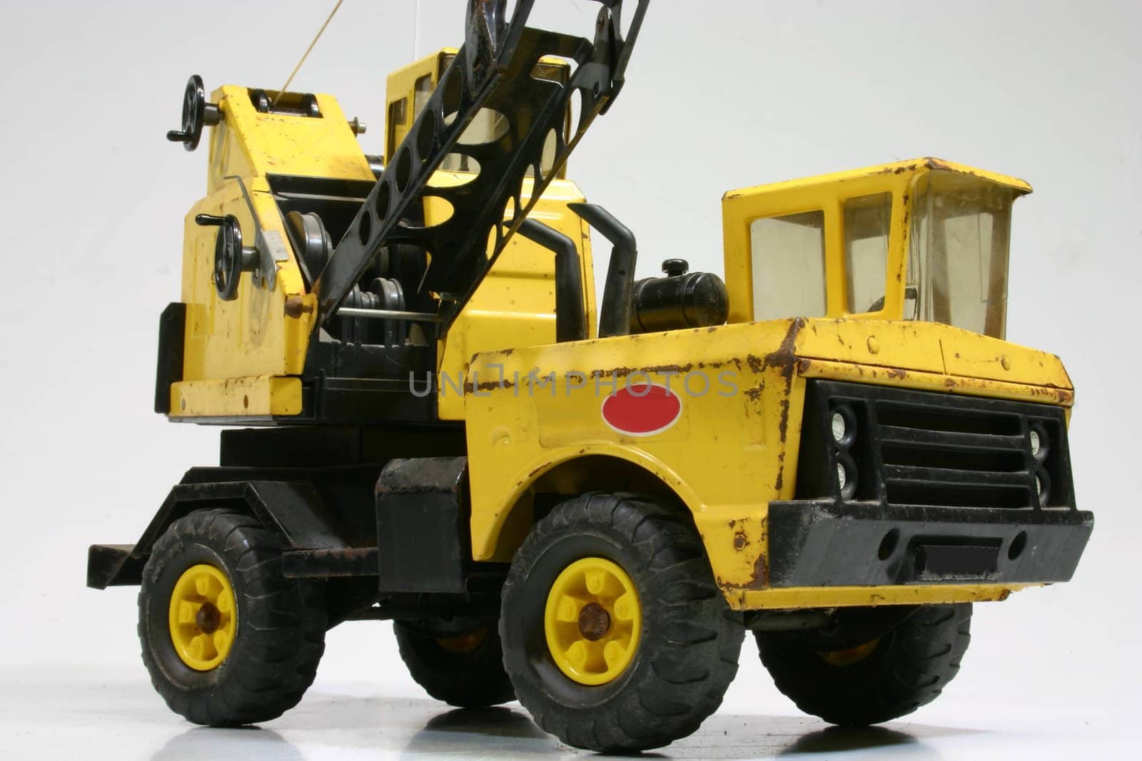 Vintage toy crane truck on a white background.