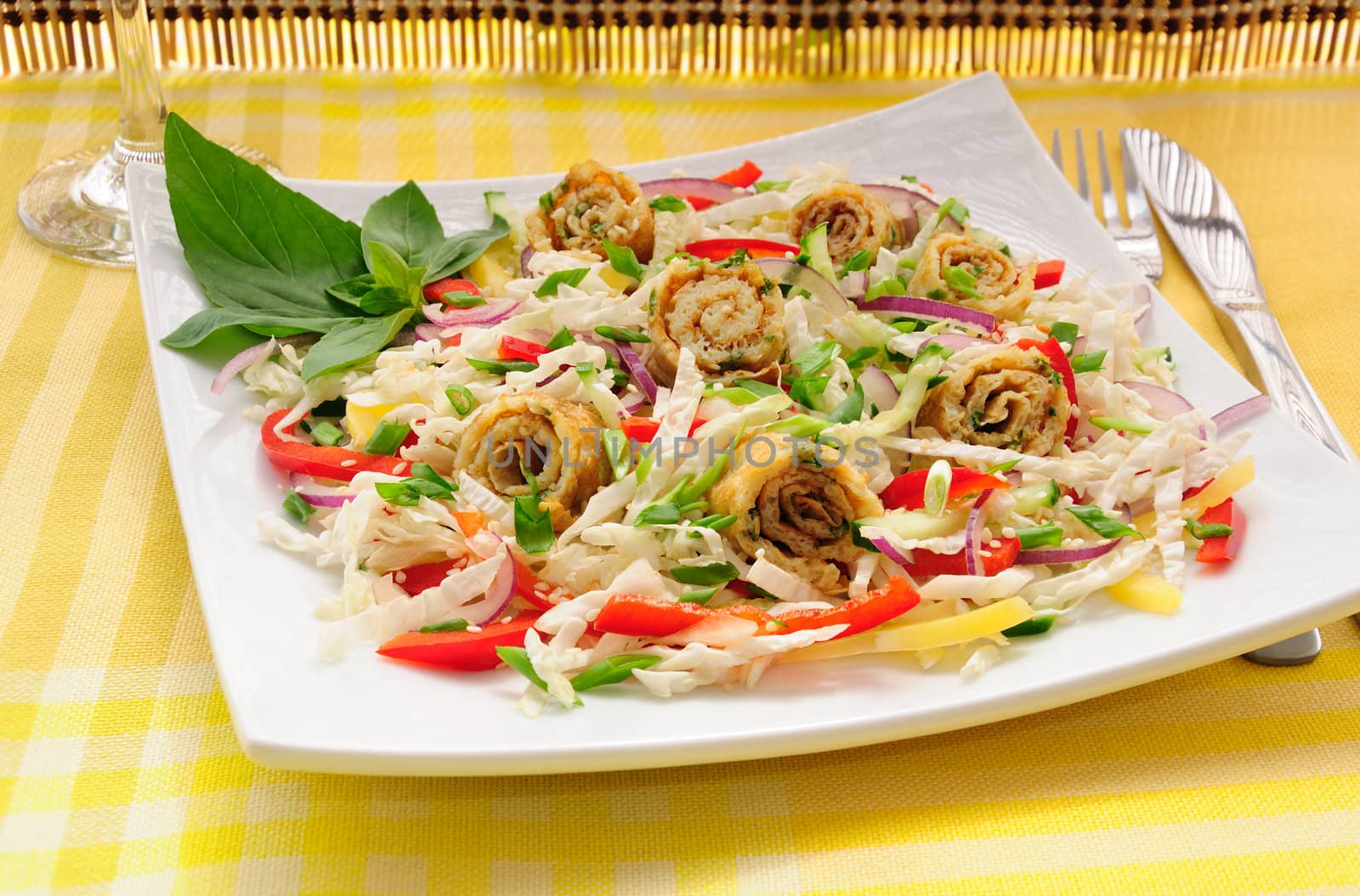 Scrambled eggs with green onions, fresh vegetables and sesame seeds