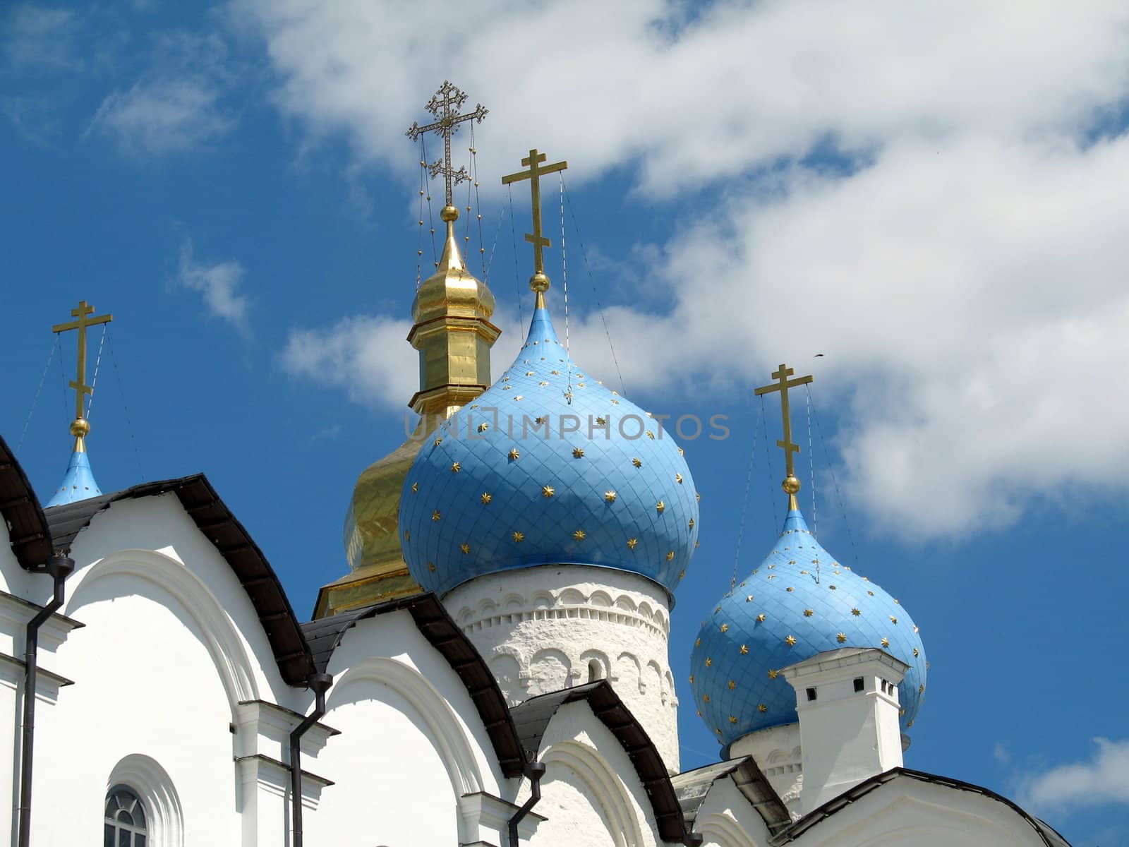 Domes of an orthodox temple on a background of the light-blue sky by SergeAT