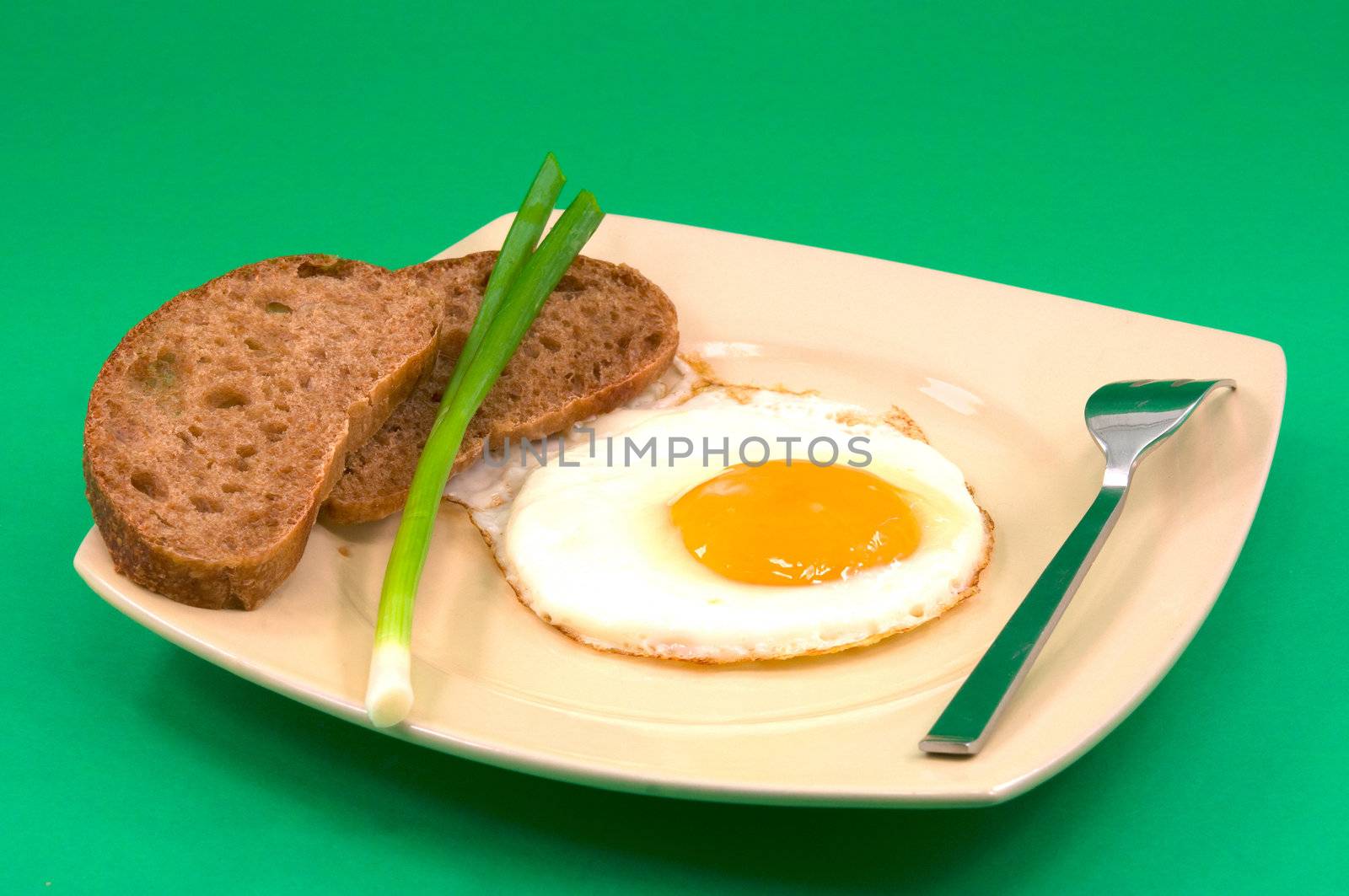 
fried eggs from one egg with bread and green onion