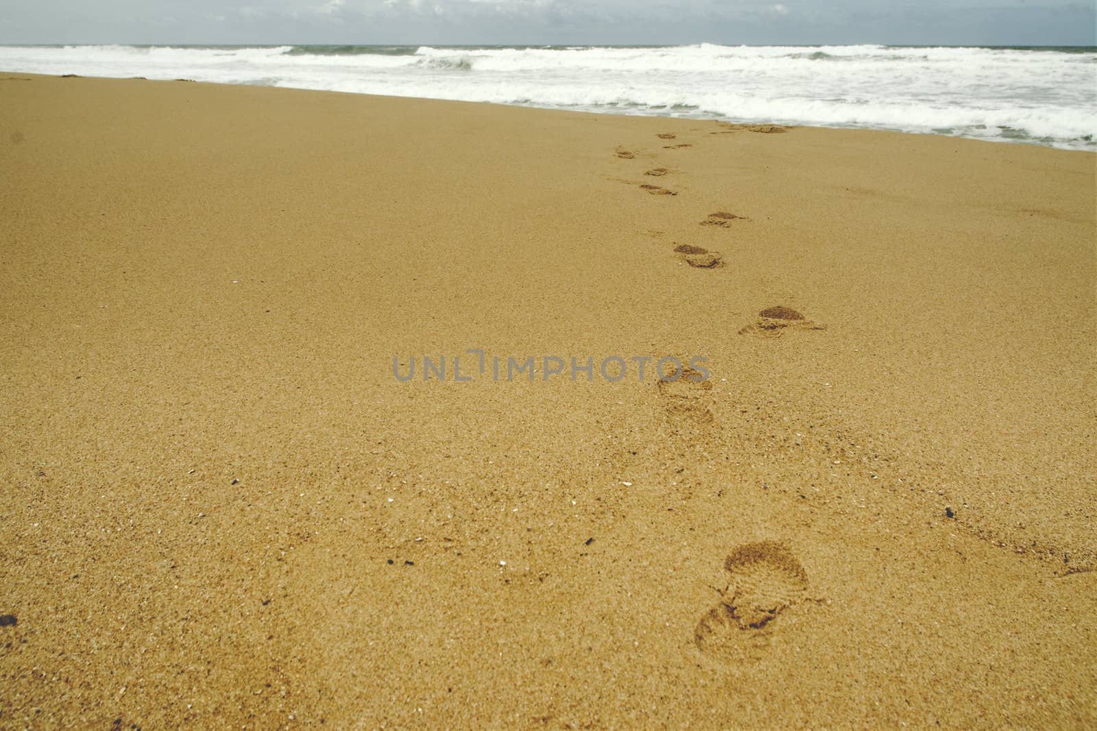 Footsteps at beach on a stormy day
