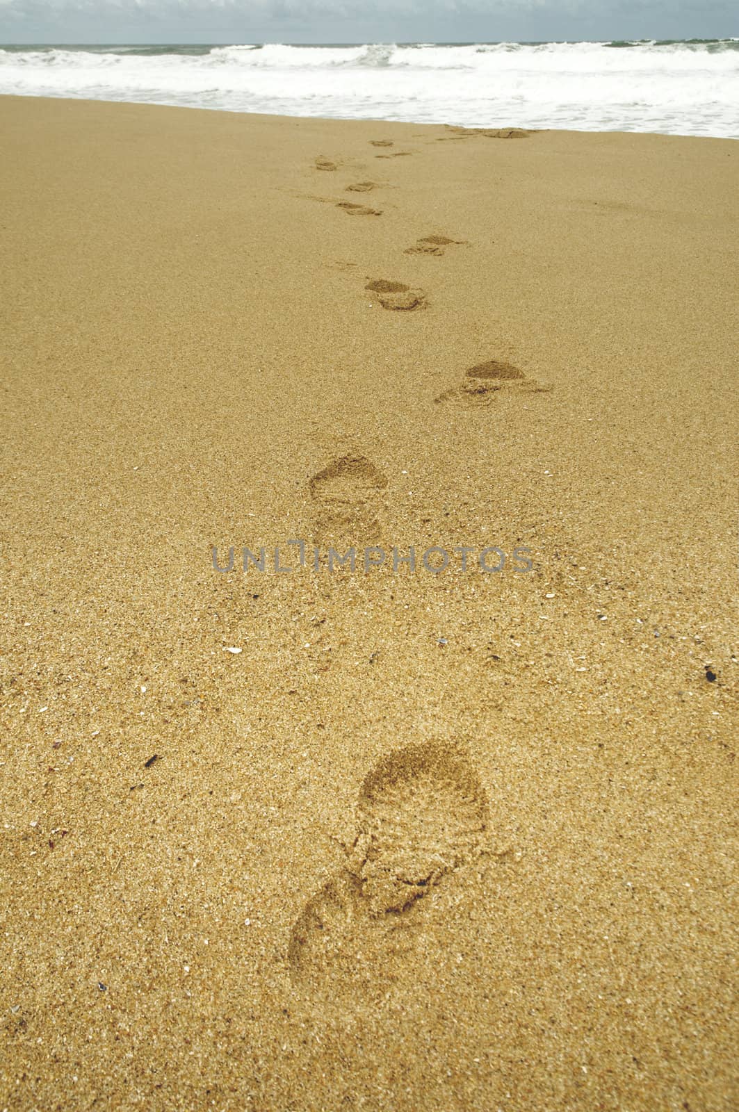 Footsteps at beach on a stormy day