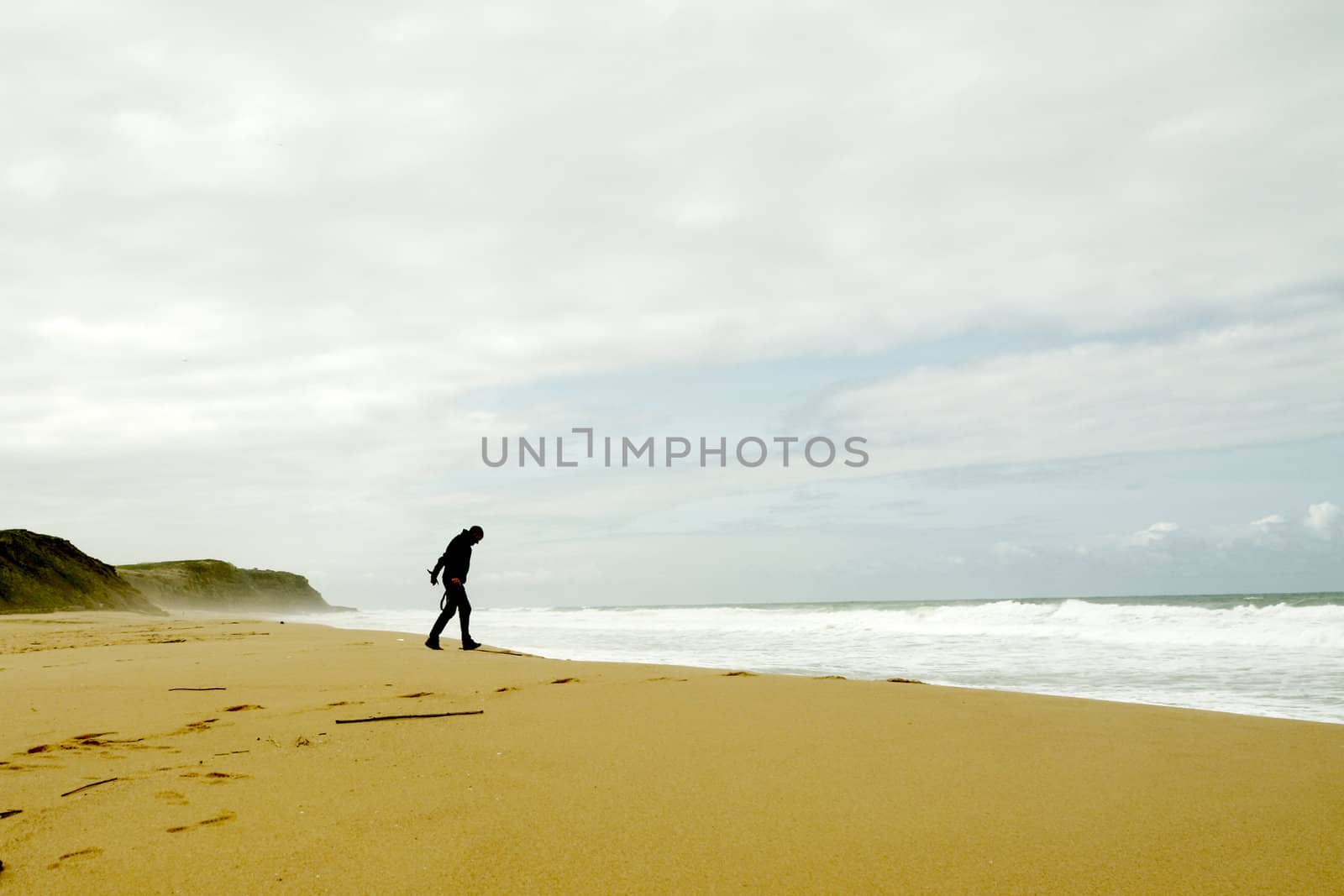 Man walking towards the waves
