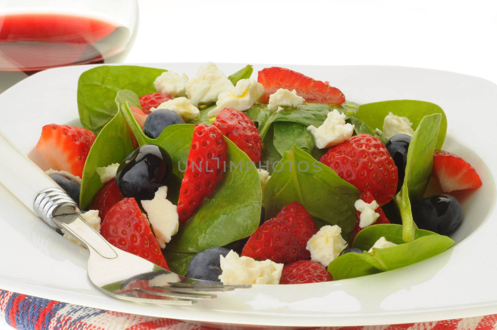 Colorful summer salad of greens, fruit and feta cheese.