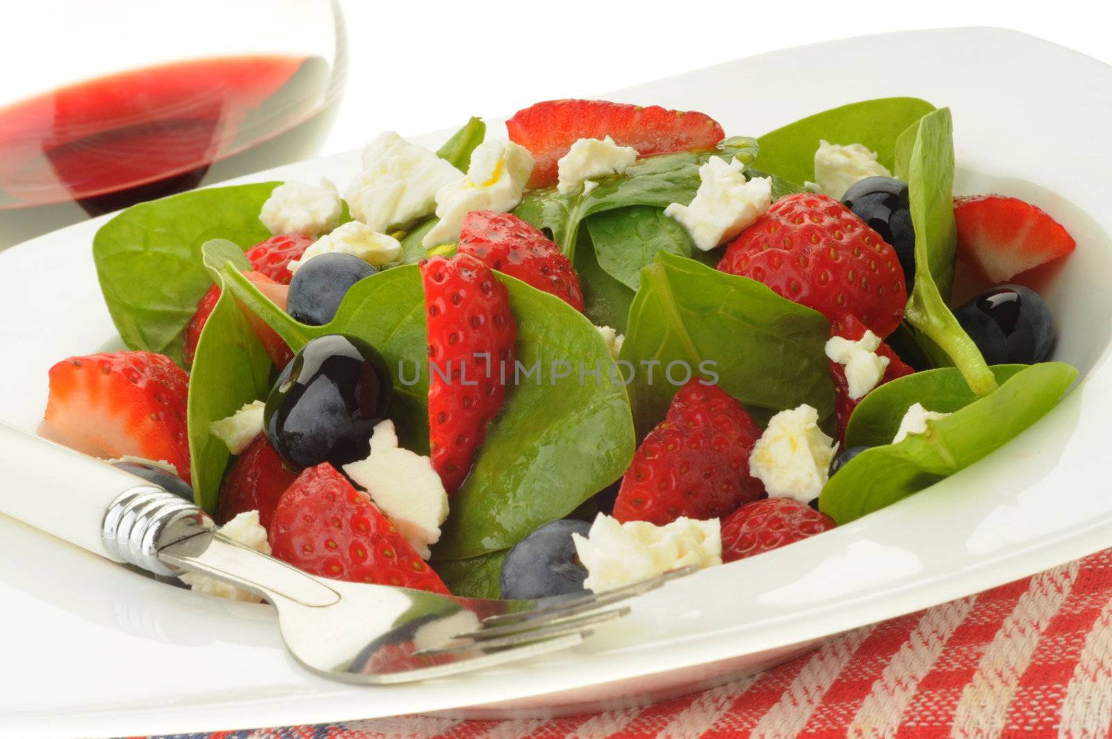Fresh green salad with berries and feta.