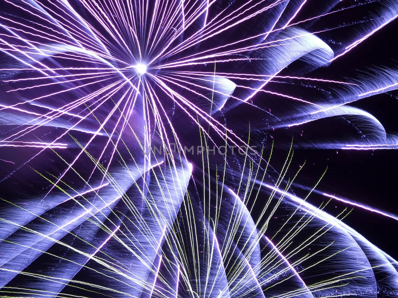 blue and purple fireworks in a dark sky
