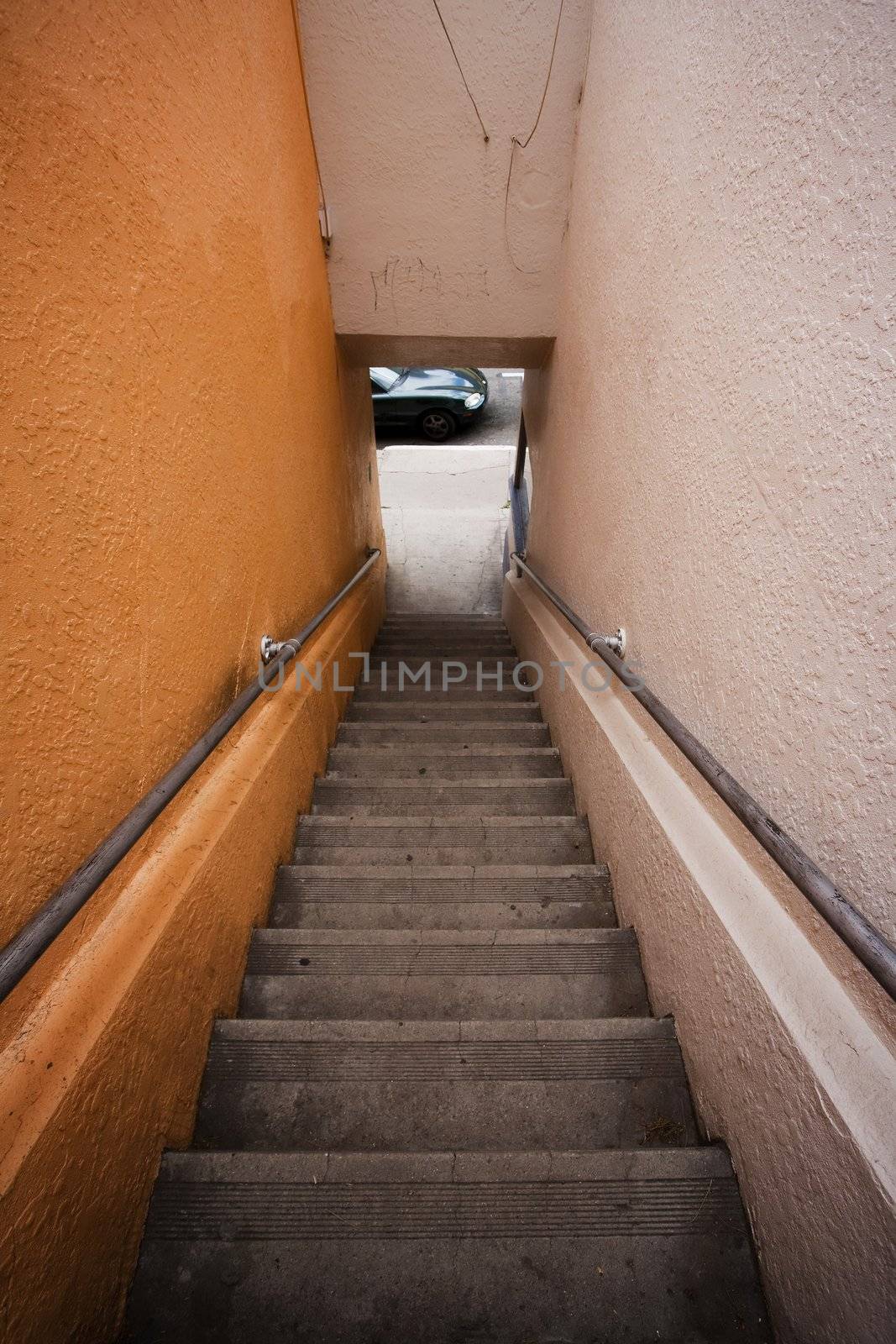 Long stairway to street where car is parked