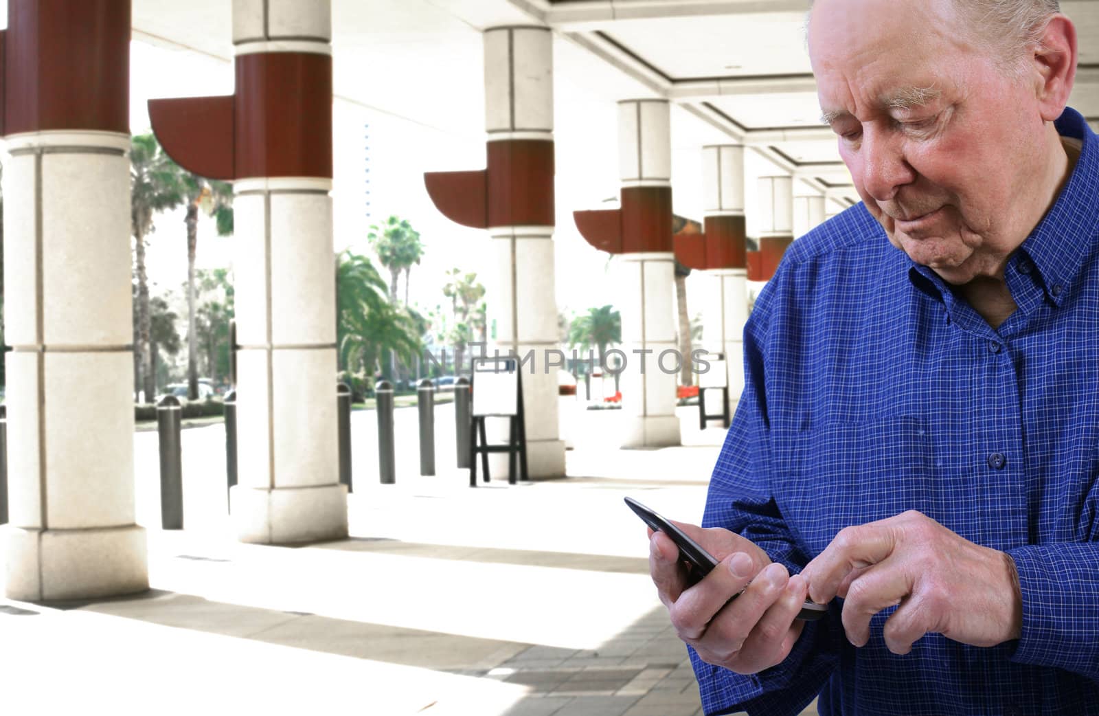 Elderly man  dialing cell phone