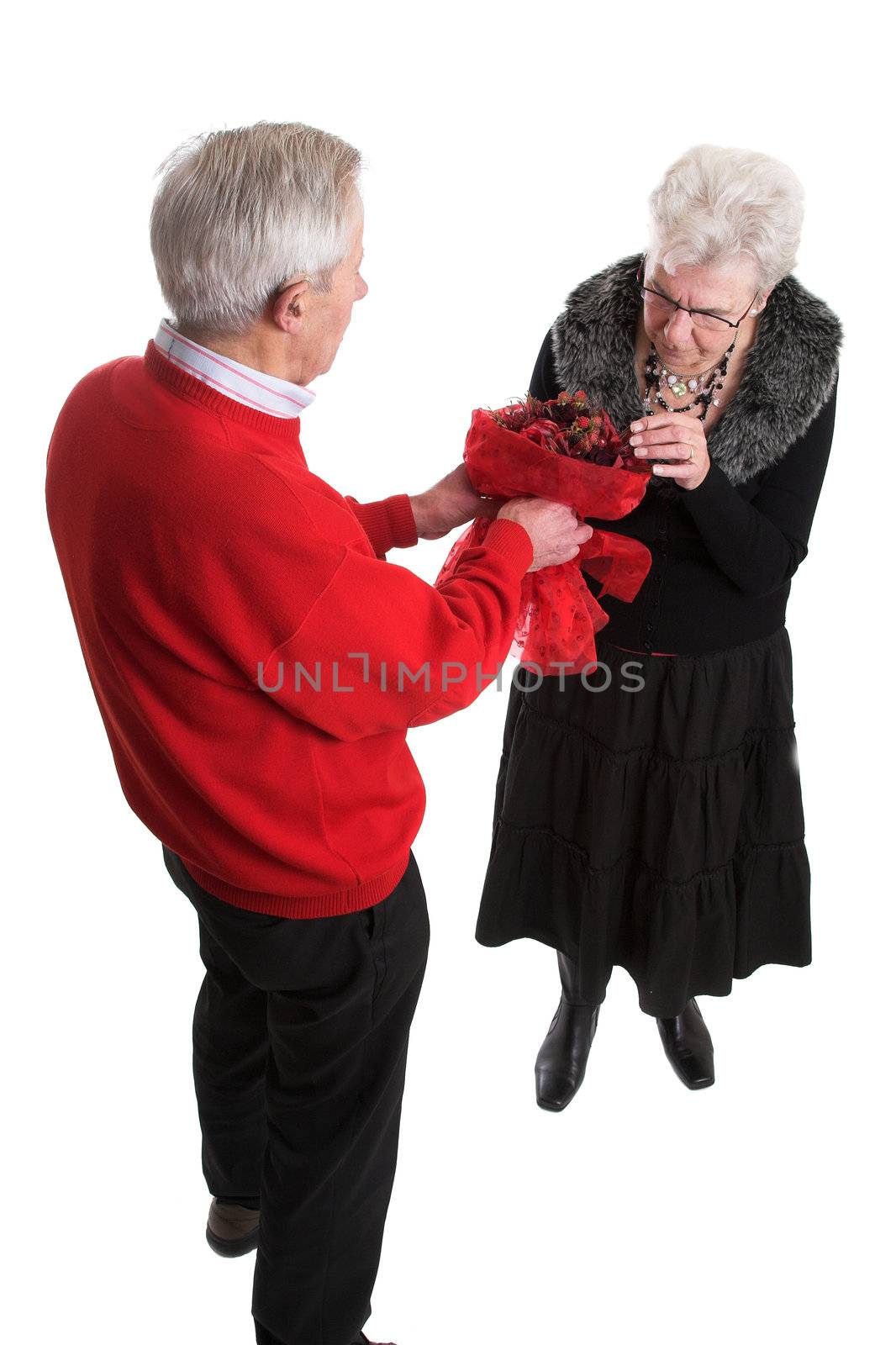 Elderly man giving his wife flowers for Valentines day