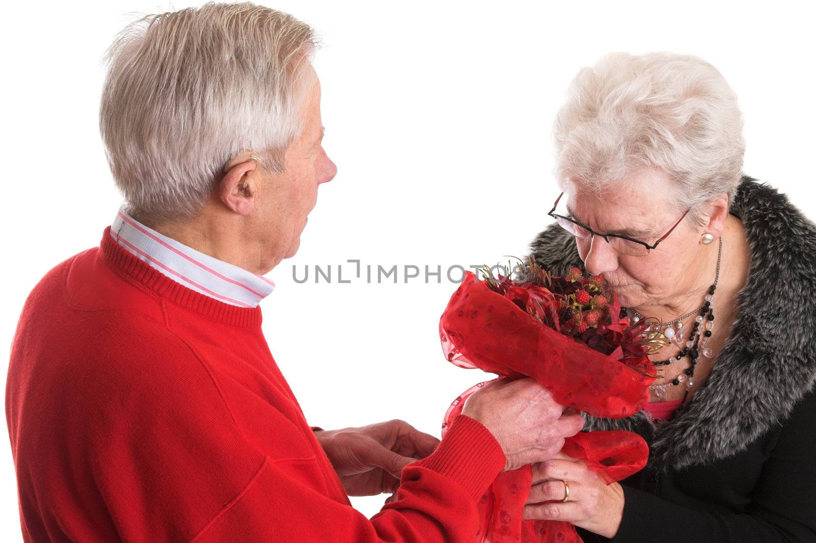 Elderly man gives his wife a bunch of flowers for valentine
