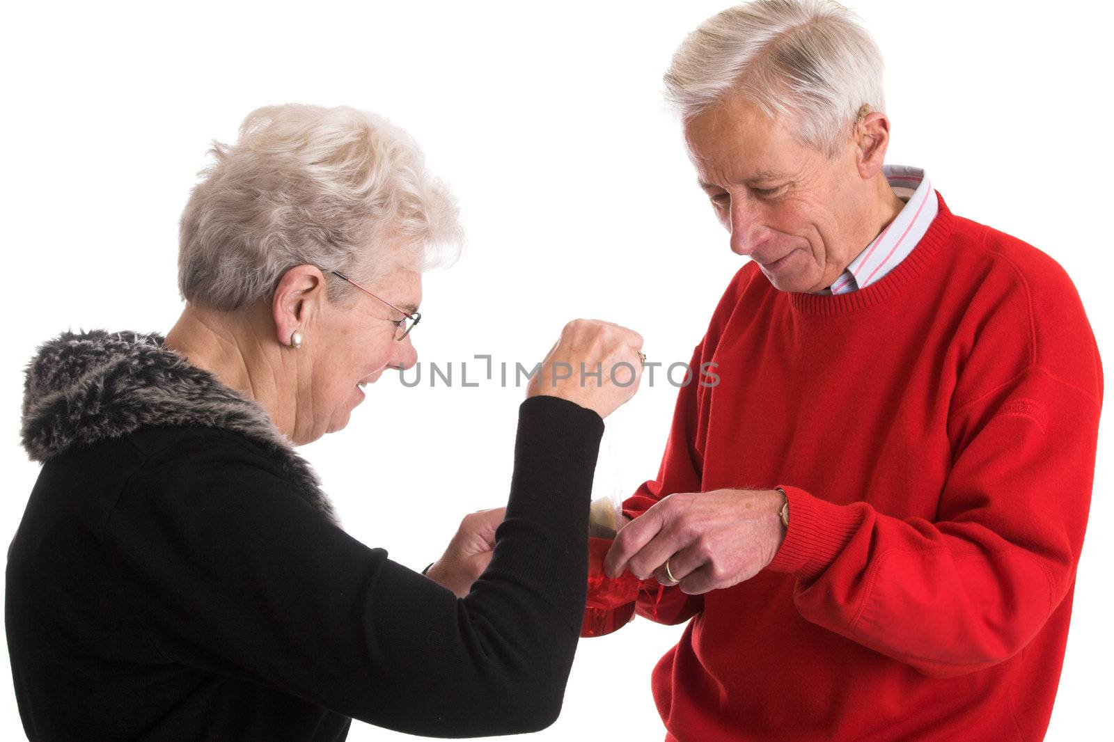 Elderly woman giving valentine chocolates to his wife
