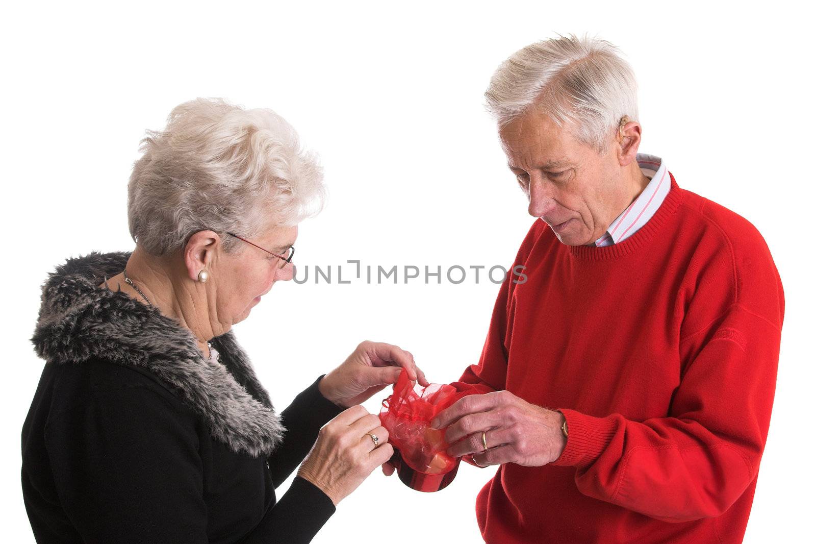 Elderly couple together holding a box of chocolate