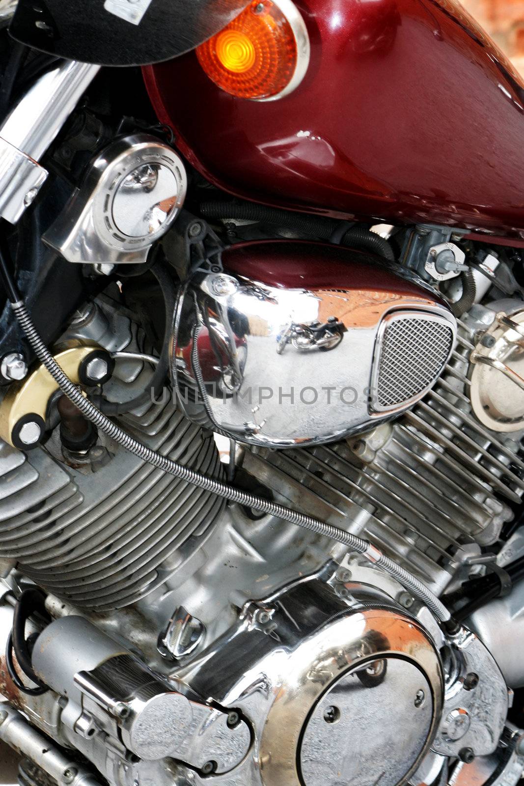 The engine of a motorcycle with a red petrol tank