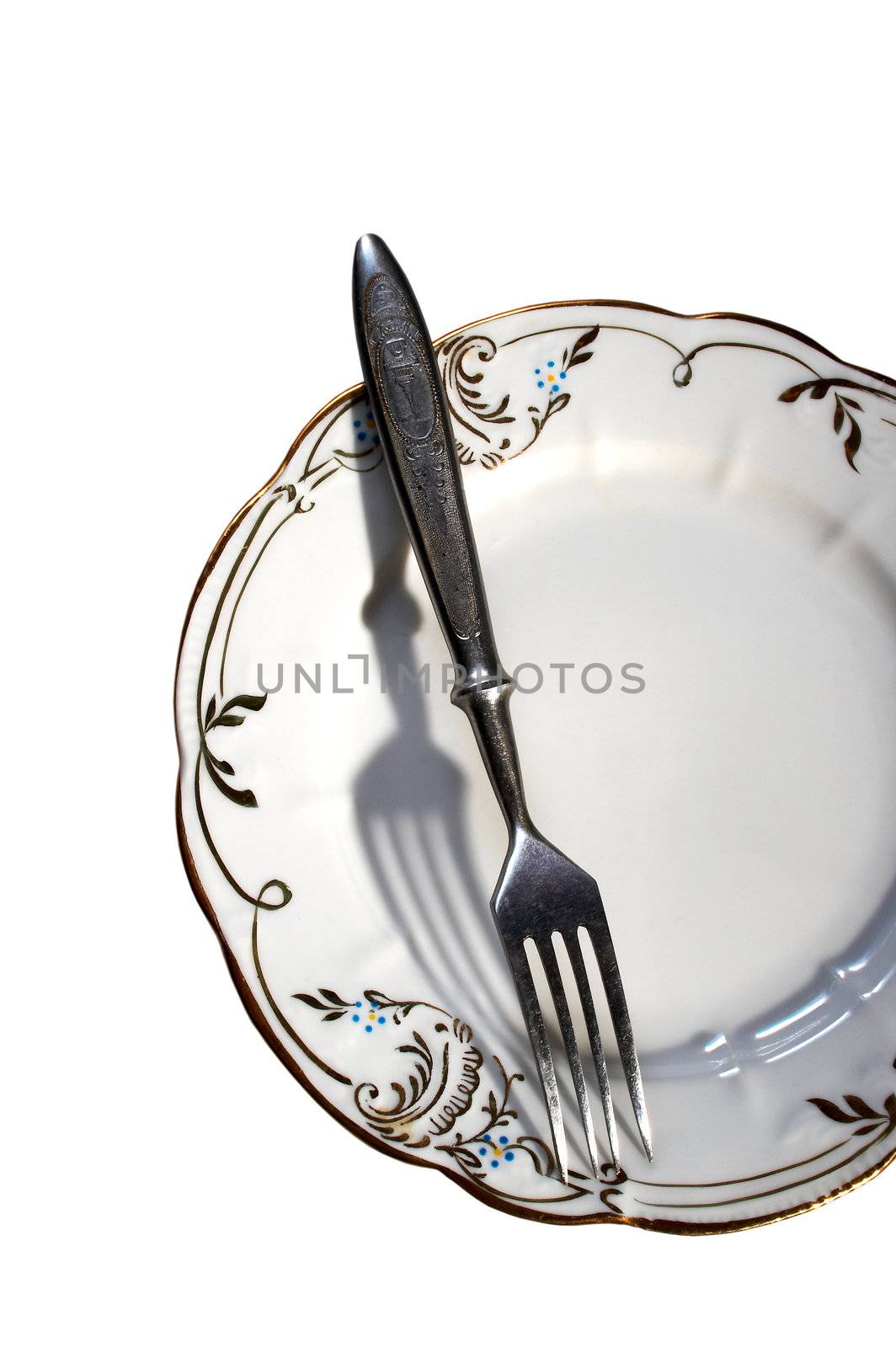 Plate and fork on a white background